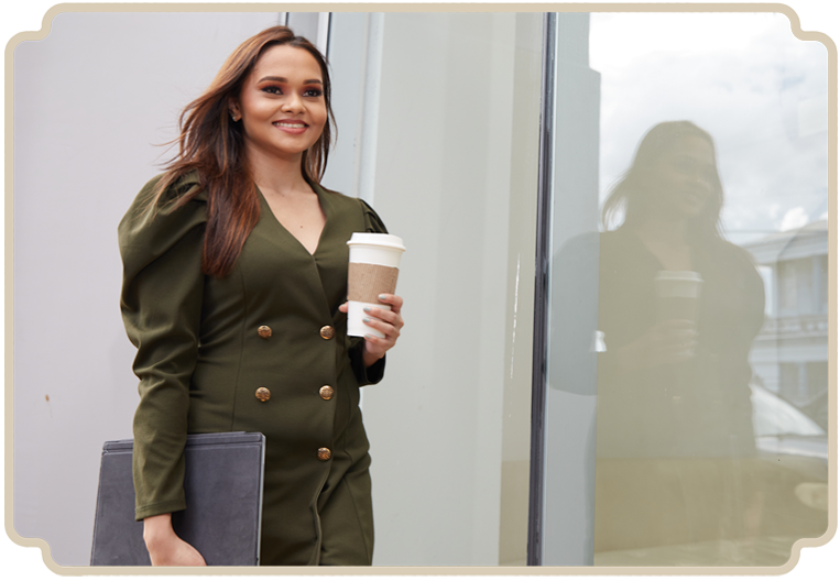 Professional woman in business attire confidently holding a cup.