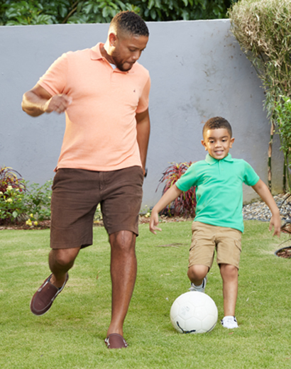 Father and son playing football in their backyard because of a Switch Mortgage
