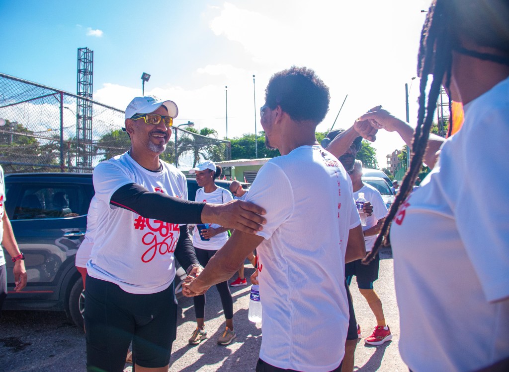 Image of (l-r) Larry Olton - General Manager – Operations (Ag.), First Citizens greets Brian Lewis after completing the 26.2 mile 10th TTOC Gold Foundation Walk.