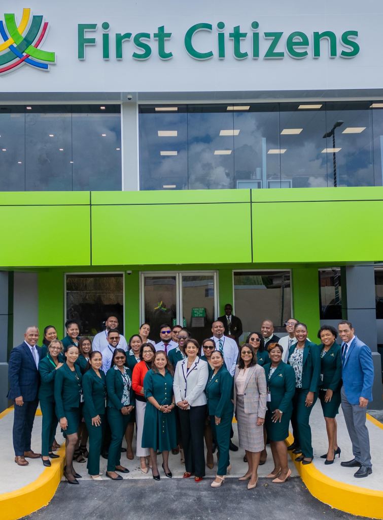 Sangre Grande Staff posing infront of Branch at the opening ceremony