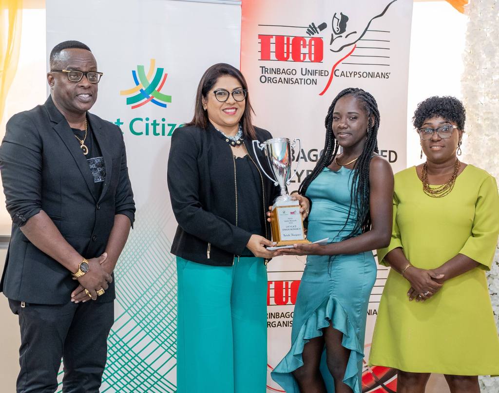 2024 Junior Calypso Monarch Nataki Thompson captured as she receives her winnings from First Citizens Group Deputy CEO - Operations and Administration, Ms. Neela Moonilal-Kissoon Pic 2 – First Citizens Group Deputy CEO – Operations and Administration, Ms. Neela