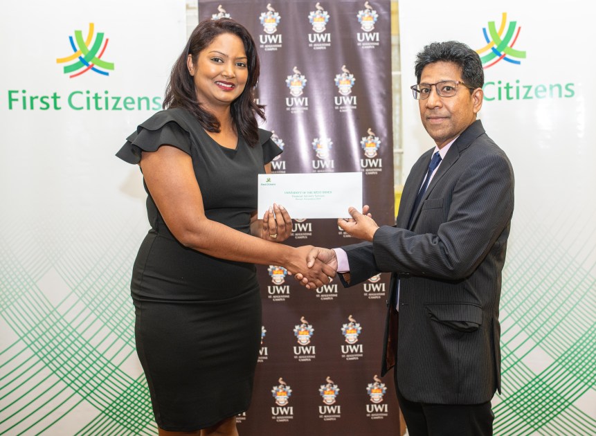 Tamara Ramlogan, Assistant Branch Manager of First Citizens Tunapuna, presents a bursary to Prof. Derek Chadee, Campus Deputy Principal UWI St. Augustine strengthening a longstanding partnership committed to fostering academic excellence.