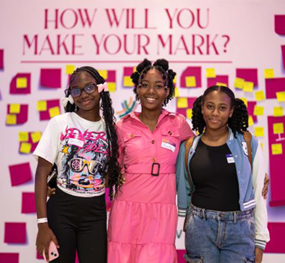 Three young girls posing at the girls first festival 2025