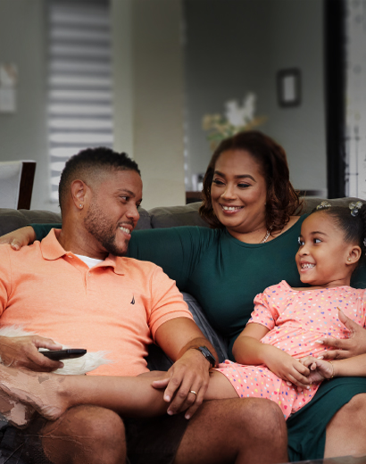 family sitting together in their living room with a switched mortgage