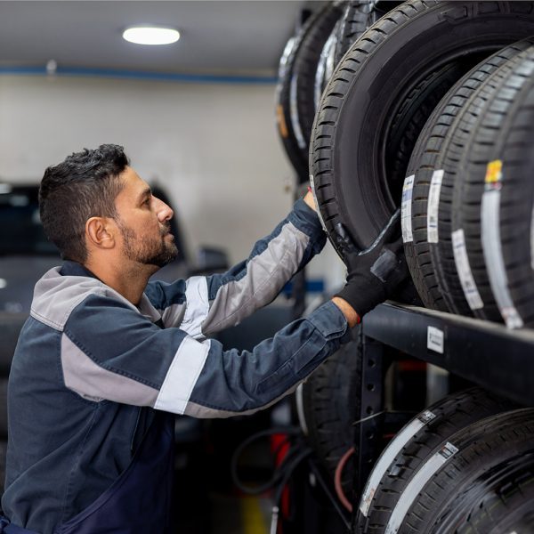 Guy selecting tyres from a rack fuel your next move
